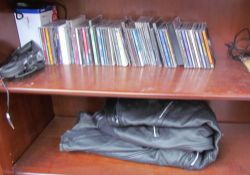 A pair of leather motorcycle trousers together with assorted CD's etc