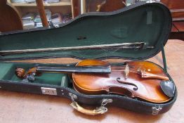 A violin and bow, bears a label, imported by Leslie Sheppard, cased, 59cm long overall,
