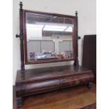 A Victorian mahogany toilet mirror with a rectangular plate and two drawers on splayed legs