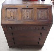 A 20th century oak bureau together with an oak gate leg dining table and a nest of three tables