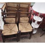 A set of four dining chairs with bar backs and rush seats together with a cast iron three tier