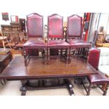 An oak extending dining table with a rectangular top and pull out leaves on cup and cover legs