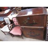 A 20th century chinoiserie decorated cocktail cabinet, with a hinged lid and mirrored interior,