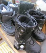 A Pair of size 7 ski boots together with a pair of size 5 ski boots
