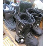 A Pair of size 7 ski boots together with a pair of size 5 ski boots