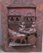 A Balinese carved panel and Balinese painting together with a poke work mirror, watercolour,
