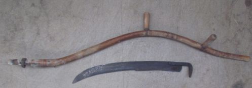 A scythe with a shaped handle