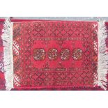 A small Turkoman rug with four guls together with another Turkoman rug with multiple guls and