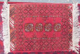 A small Turkoman rug with four guls together with another Turkoman rug with multiple guls and