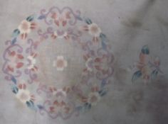 A Chinese rug with a cream ground and flowers