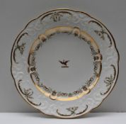 A Swansea porcelain plate, with a gilt highlighted moulded border and a central crest,