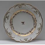 A Swansea porcelain plate, with a gilt highlighted moulded border and a central crest,