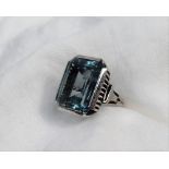 A topaz dress ring, the rectangular faceted light blue topaz,