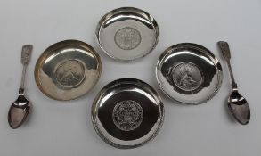 A set of four white metal dishes each set with Marie Theresia Thalers, marked Pak 94 Sil,