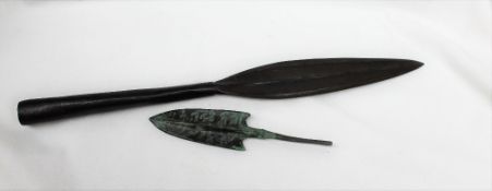 A bronze arrow head, the blades inscribed,