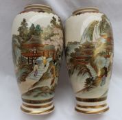 A pair of Japanese satsuma pottery vases decorated with geisha under a cherry blossom tree and
