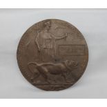 A World War I bronze death plaque,