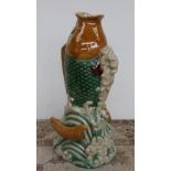 A large tin glazed earthenware fish vase, depicting a fish leaping from the waves,