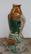 A large tin glazed earthenware fish vase, depicting a fish leaping from the waves,