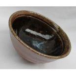 Phil Rogers - a studio pottery pedestal bowl with a blue splash and brown glaze, impressed mark,