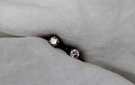 A pair of diamond stud earrings, set with round brilliant cut diamonds each approximately 0.