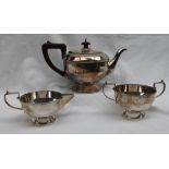 A George V silver three piece teaset, comprising a teapot, cream jug and twin handled sugar basin,