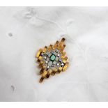 An 18ct yellow gold emerald and diamond pendant / brooch,