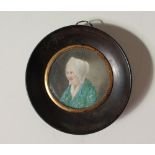 19th century British School Head and shoulders portrait of a lady A circular miniature on