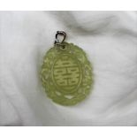 A light green jade panel, of oval form, pierced, with dragon carving and line decoration,