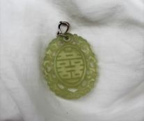 A light green jade panel, of oval form, pierced, with dragon carving and line decoration,