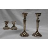 A pair of Elizabeth II silver desk candlesticks, with a tapering column and spreading foot,