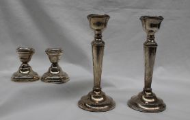 A pair of Elizabeth II silver desk candlesticks, with a tapering column and spreading foot,