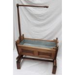 A Swiss pine cradle, with penwork decorated panels, on a later stand and inset zinc planter,