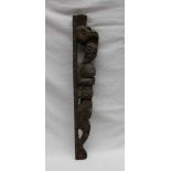 A carved oak moulding depicting a figure, traces of painted decoration still present,