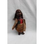 A New Zealand Maori doll, the composition head with painted features, to a composition body,