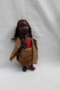 A New Zealand Maori doll, the composition head with painted features, to a composition body,