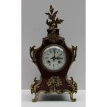 A French tortoiseshell and gilt metal mantle clock, with a scroll and leaf cresting,
