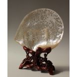 A Chinese carved and pierced mother of pearl shell, decorated with a crane, bird of paradise,