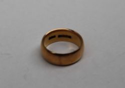 An 18ct gold wedding band, approximately 9.