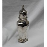 A George V silver sugar caster with a domed pierced top and a panelled body and spreading foot,