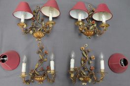 A set of four gilt metal two branch wall lights,