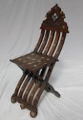 A middle Eastern hardwood folding chair, the ogee shaped back with mother of pearl inlay,