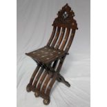 A middle Eastern hardwood folding chair, the ogee shaped back with mother of pearl inlay,