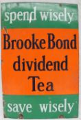 An enamel sign with bands of green and orange "Spend Wisely, Brooke Bond dividend Tea, Save Wisely",