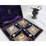A set of four silver table salts of square form, embossed with leaves on claw feet,