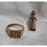 A 9ct yellow gold signet ring with the initials JD, together with a 9ct gold Welsh lady charm,