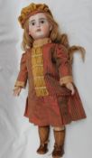An SFBJ bisque head doll, with fixed blue eyes, pierced ears and open mouth and teeth,