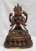 An oriental gilt bronze statue of Lakshmi seated on a leaf and bead decorated base, 25cm high x 15.