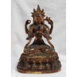 An oriental gilt bronze statue of Lakshmi seated on a leaf and bead decorated base, 25cm high x 15.