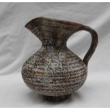 Waistel Cooper - a studio pottery jug, with a textured body in browns and cream,